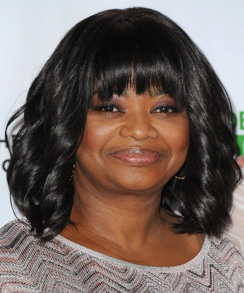 Older Black woman with soft black shoulder-length layers and loose face-framing waves