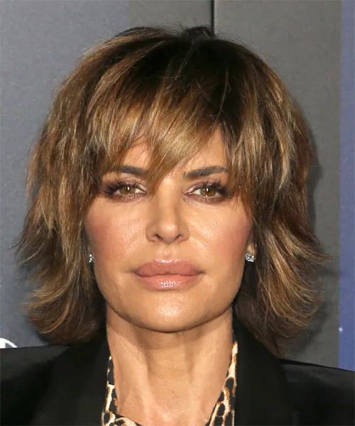 Older woman with a tousled brunette shag, layered bangs, and choppy medium movement
