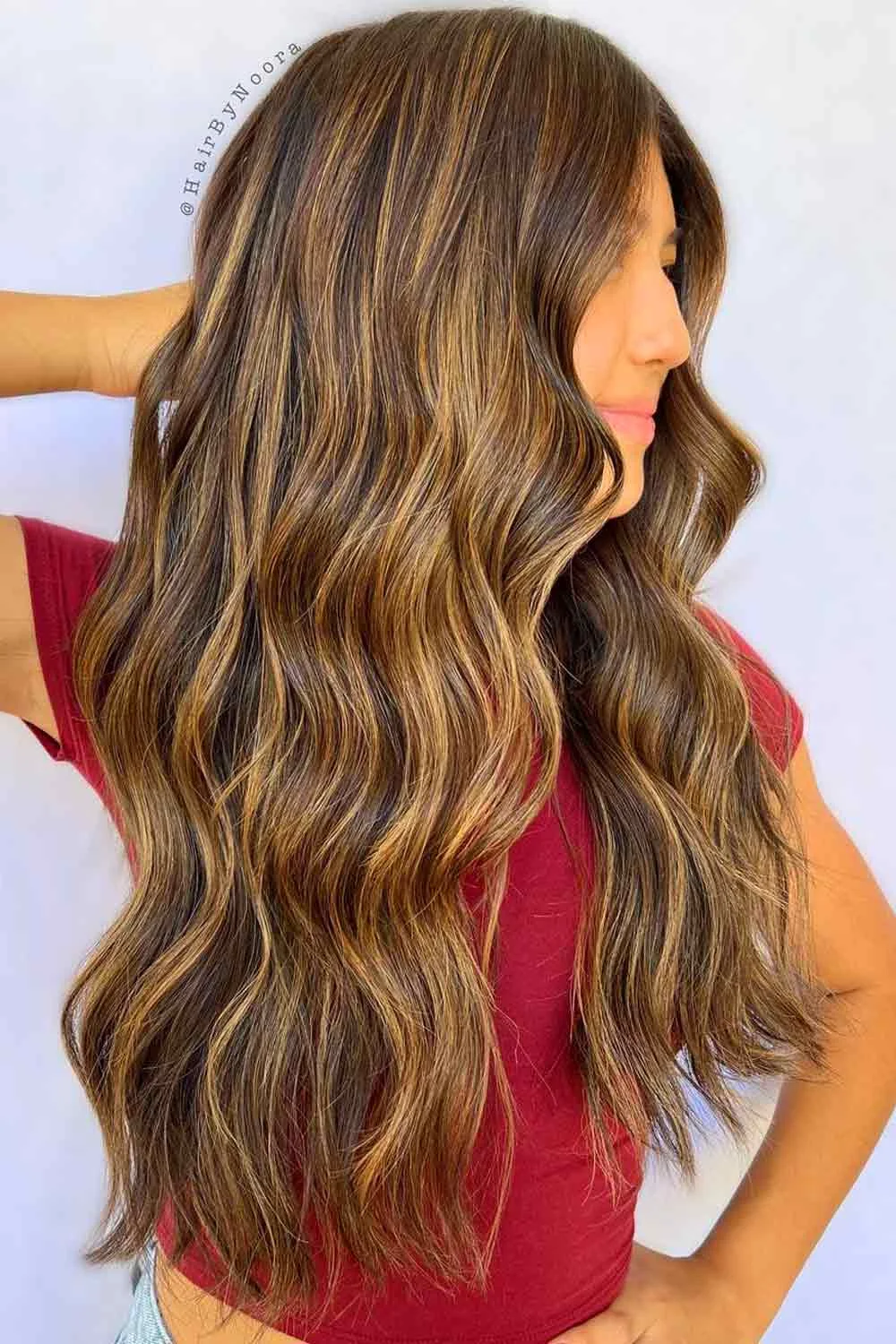 Side view of long brown waves with thin golden highlights