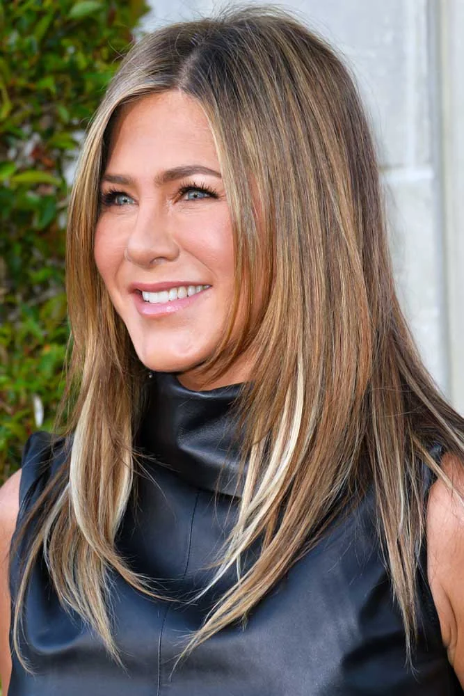 Front-side view of long light brown layers with paler strands around the face