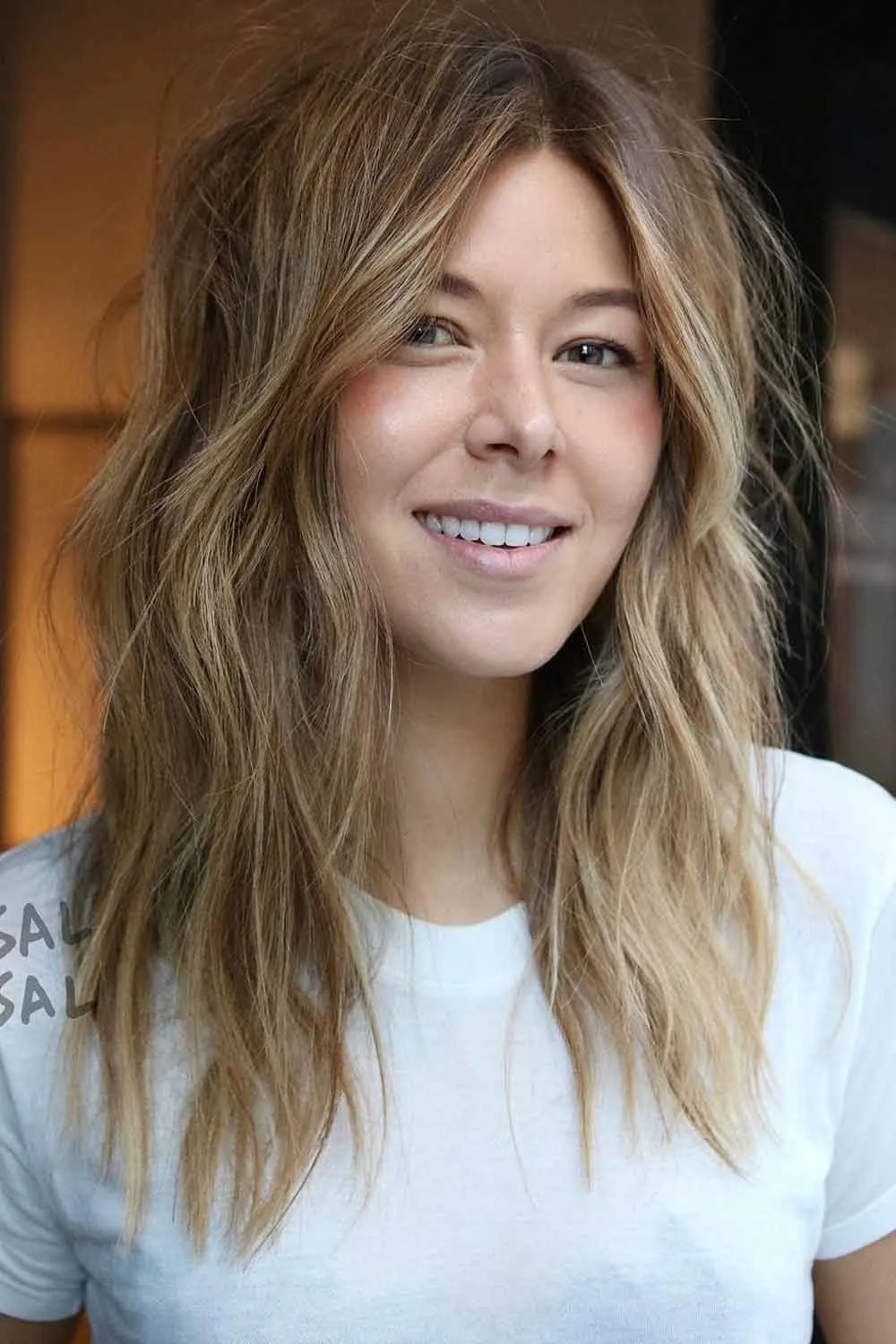 Front view of medium-length brown layers with subtle lighter ends