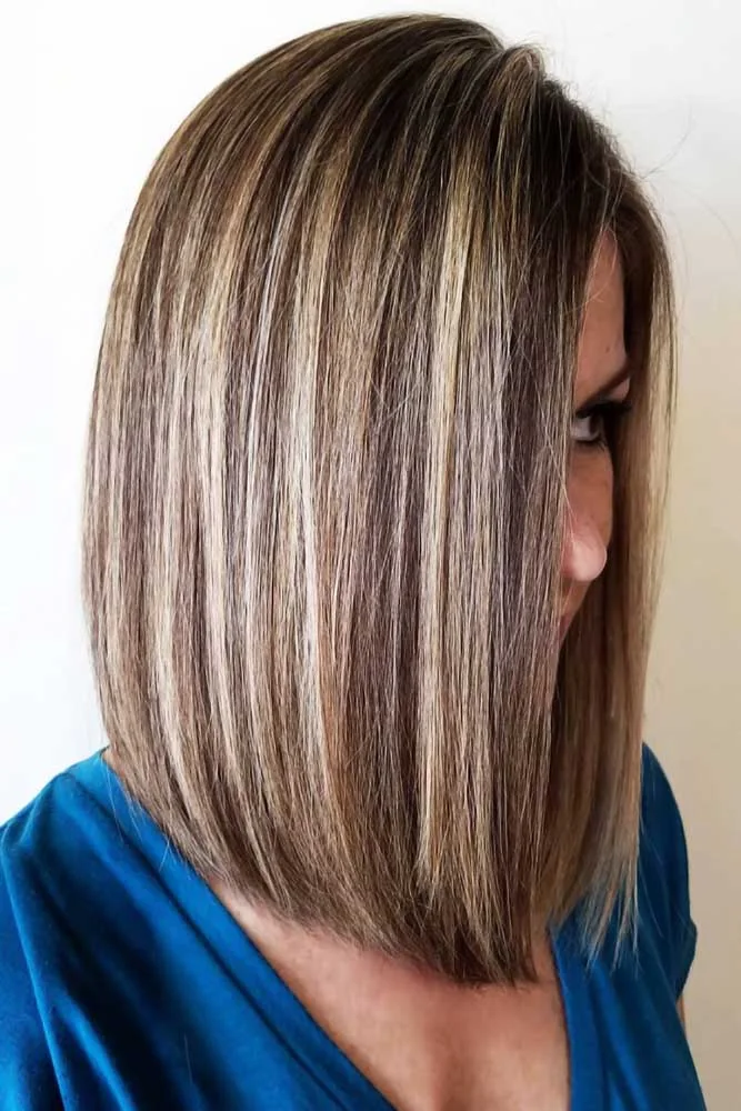 Side view of a straight brown bob with contrasting light highlight ribbons