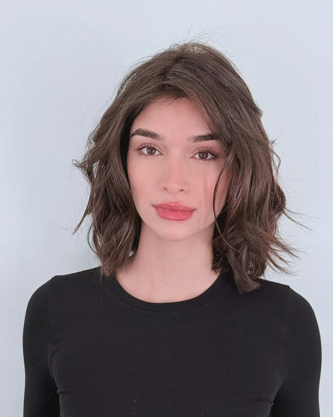 Textured brunette lob haircut with airy waves for thin hair