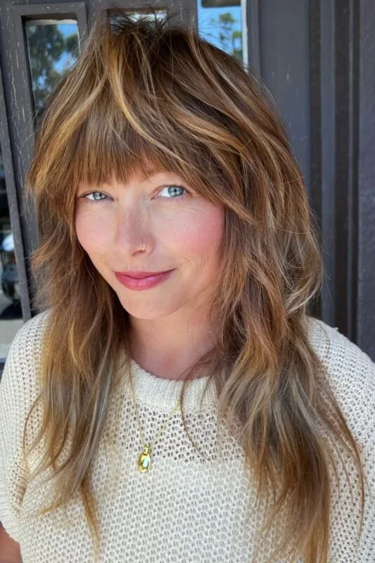 Layered lob with wispy bangs and soft brown texture for thin hair