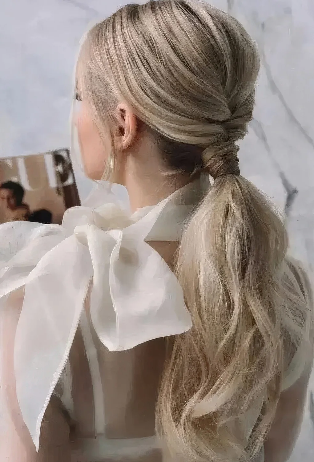 Chic low ponytail with a braided touch, a bump on top and some waves down plus locks framing the face.