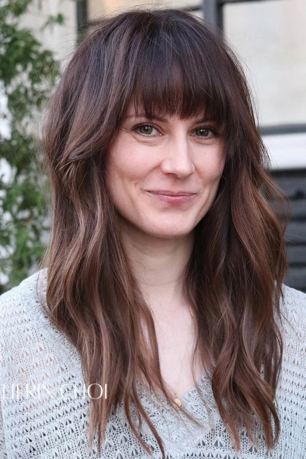 Front view of long brown hair with a full eyebrow-length fringe