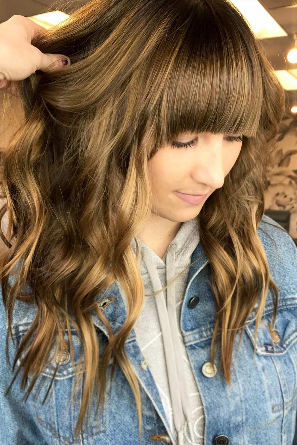 Front-side view of long brown waves with a thick-looking straight fringe