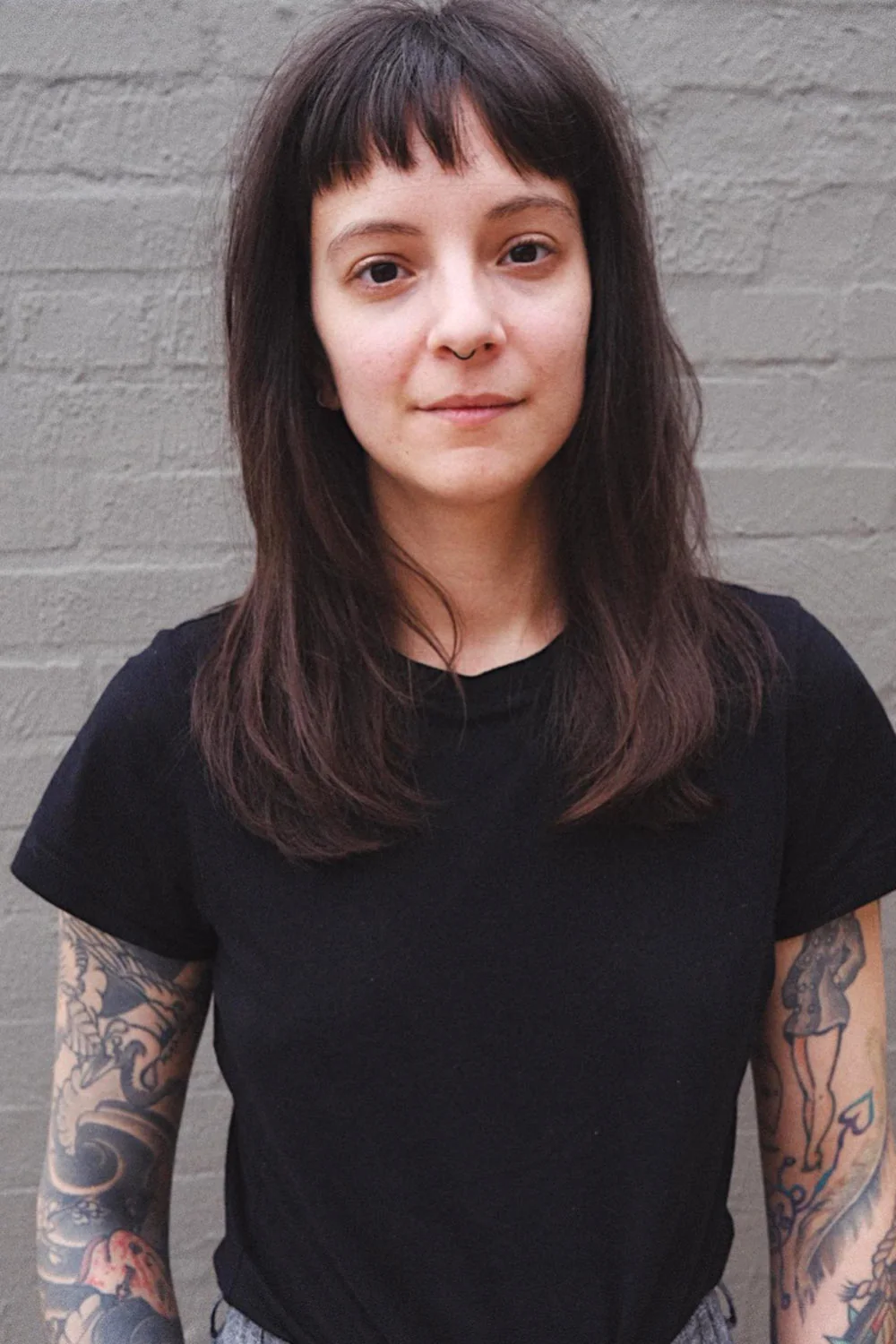 Front view of long dark hair with a short uneven fringe
