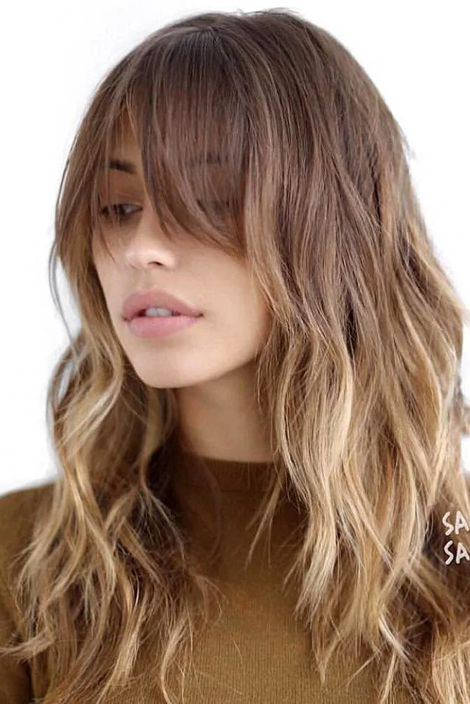 Front-side view of long brown waves with an eye-skimming fringe