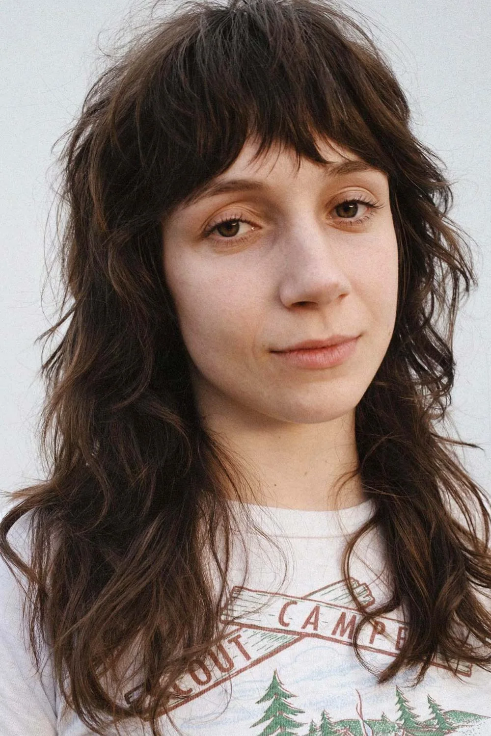 Front view of long dark shaggy layers with a short broken fringe