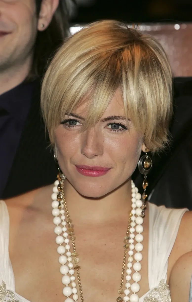 ear straight golden pixie with wispy fringe shown as a low maintenance haircuts for fine hair idea