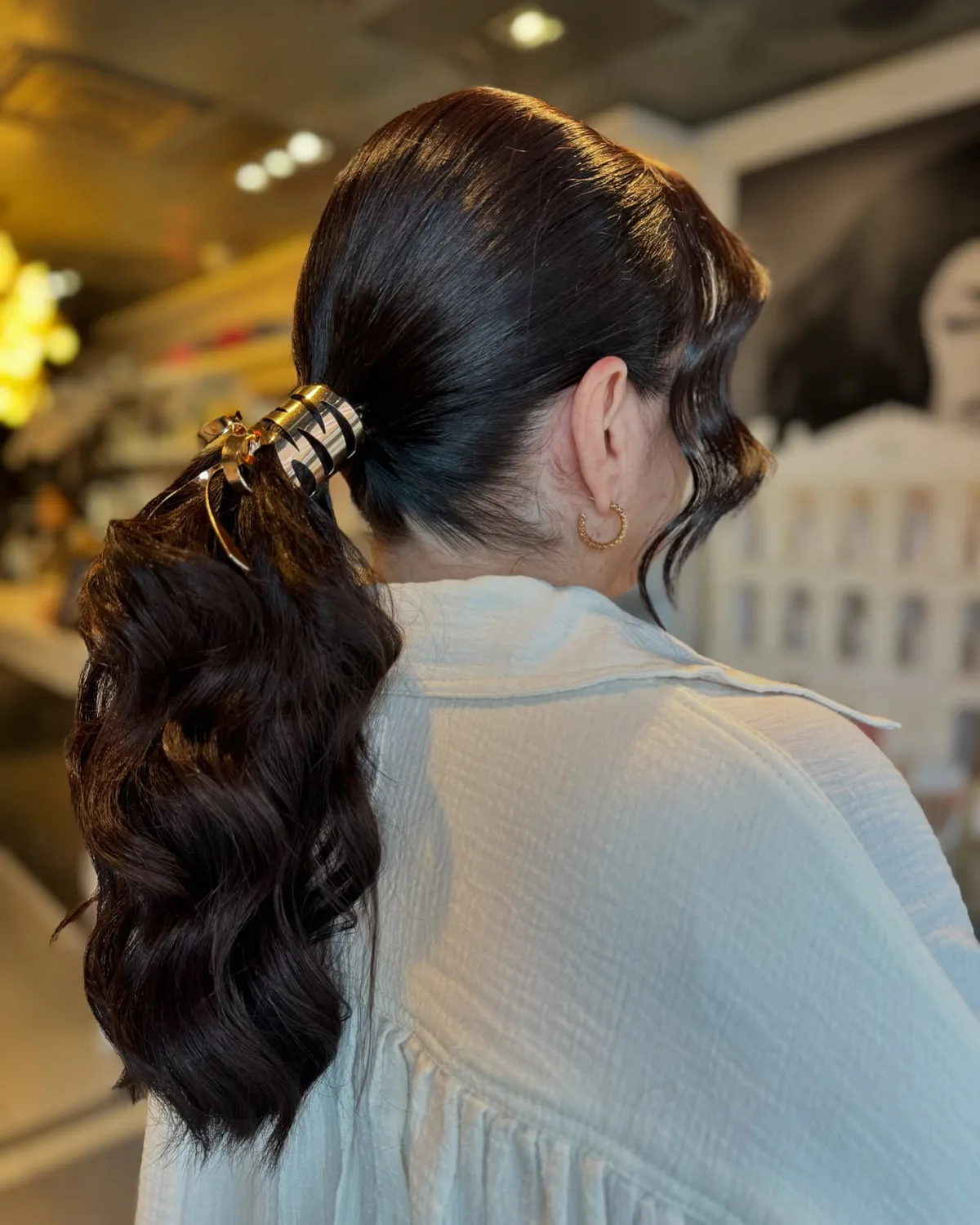 chest wavy brunette ponytail shown as a low ponytail hairstyles idea, featuring brunette color