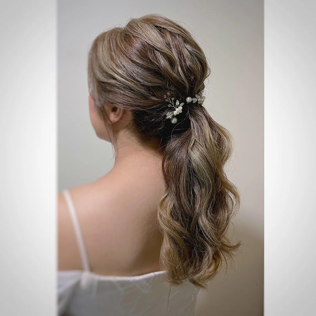 chest wavy blonde ponytail shown as a low ponytail hairstyles idea, featuring wavy texture