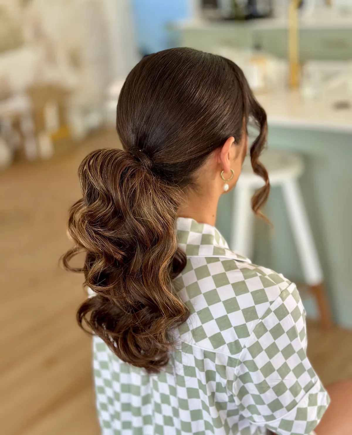 chest wavy brunette ponytail shown as a low ponytail hairstyles idea, featuring chest outline, shown in curled low ponytail with side pieces
