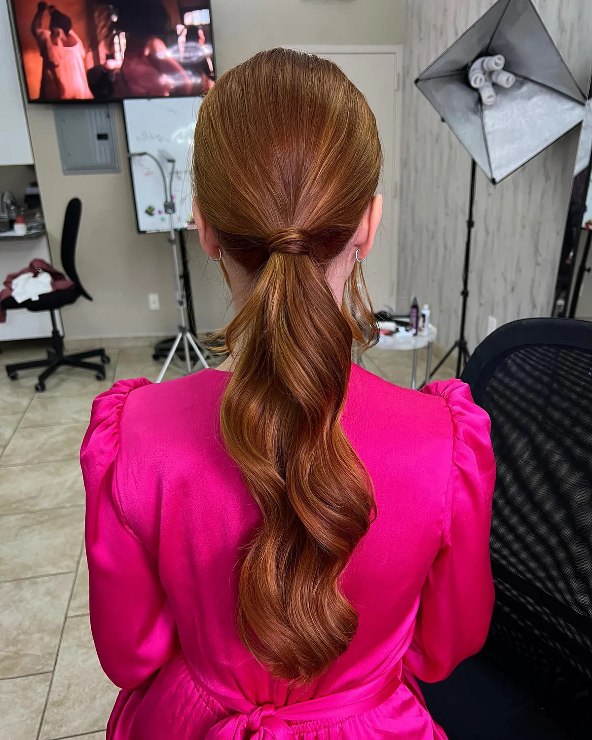 chest wavy red ponytail shown as a low ponytail hairstyles idea