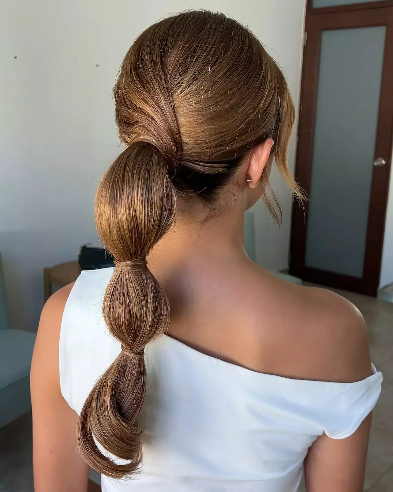 chest wavy blonde ponytail shown as a low ponytail hairstyles idea