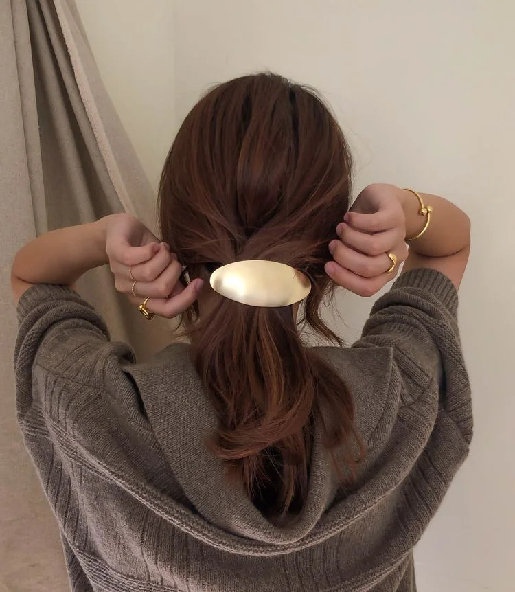 shoulder wavy chestnut half up shown as a low ponytail hairstyles idea