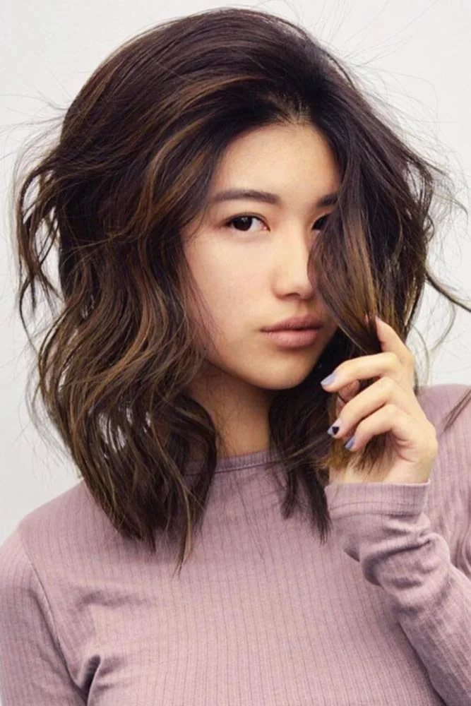 Front view of shoulder-length brown waves with a lifted side opening