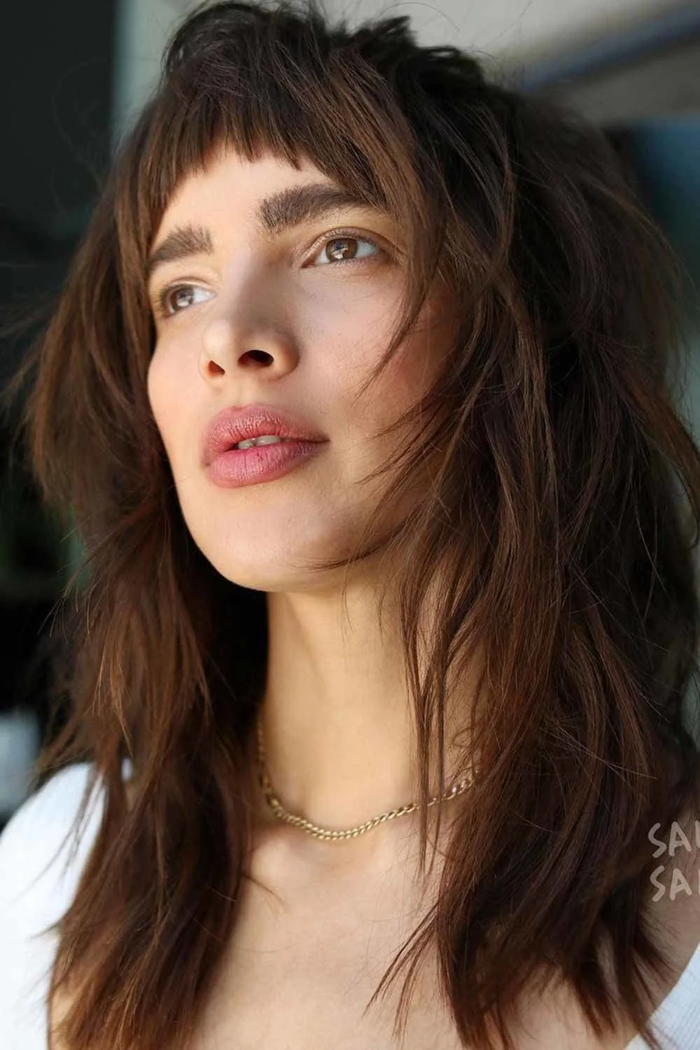 Front view of medium brown waves and a short separated fringe