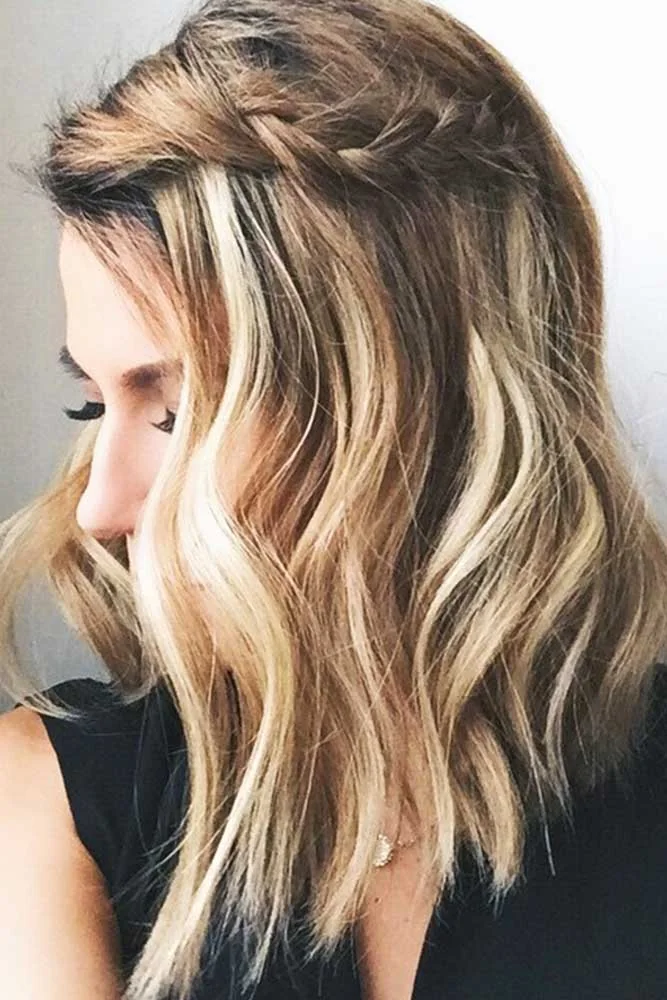 Side view of blonde shoulder-length waves with a small upper section twisted back above the ear