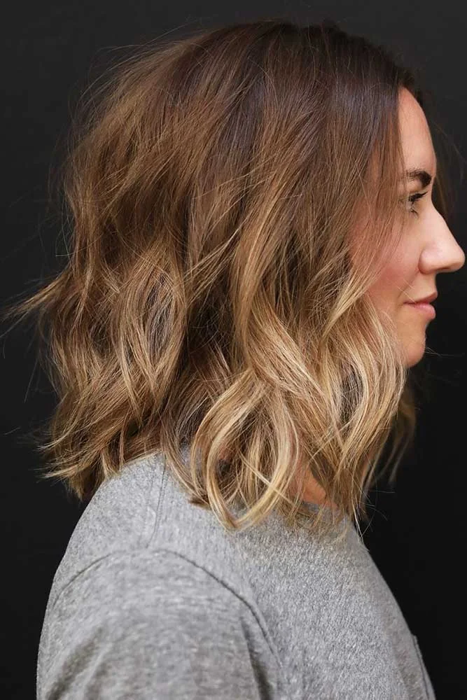 Side view of a warm brown lob with open waves and straightish ends