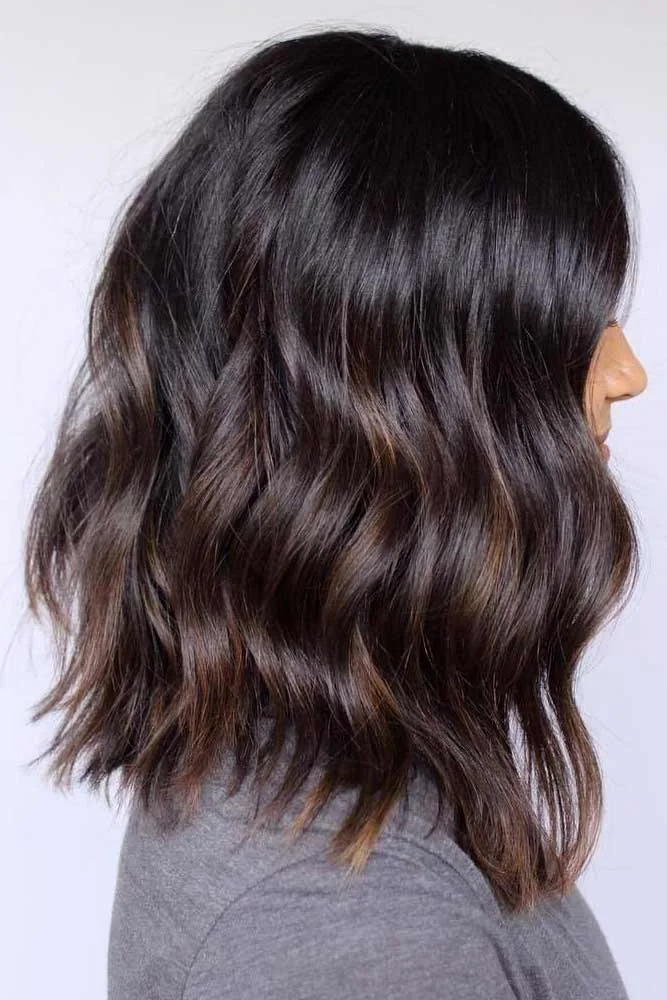 Side view of a dark medium-length lob with soft repeated waves