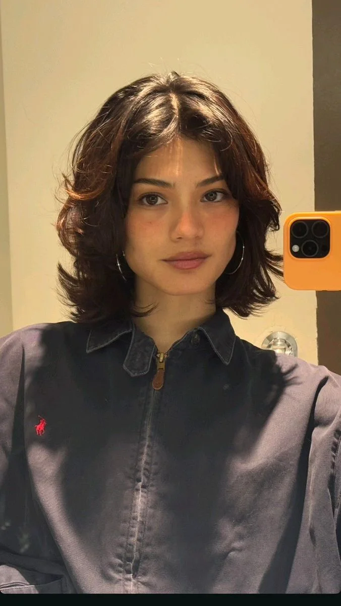 Soft brunette medium haircut with wolfy layers and face framing texture for thin fine hair