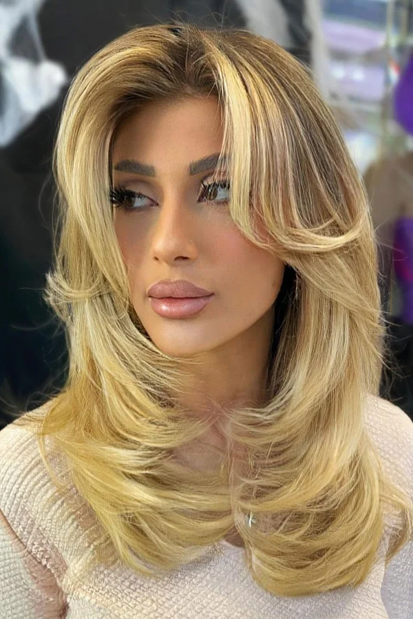 Blonde medium length haircut with face framing layers and lifted front pieces for thin fine hair