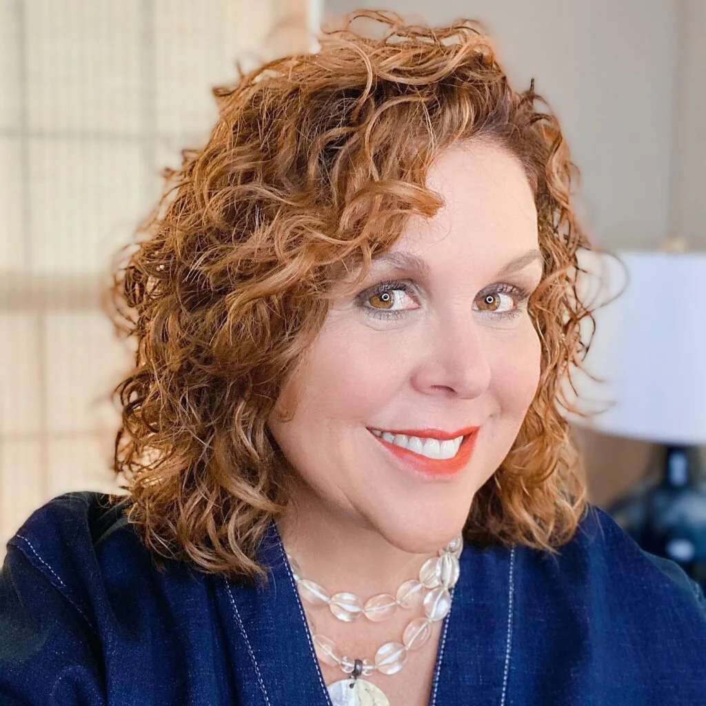 Soft curly medium shag haircut on mature hair with rounded sides for thin fine hair