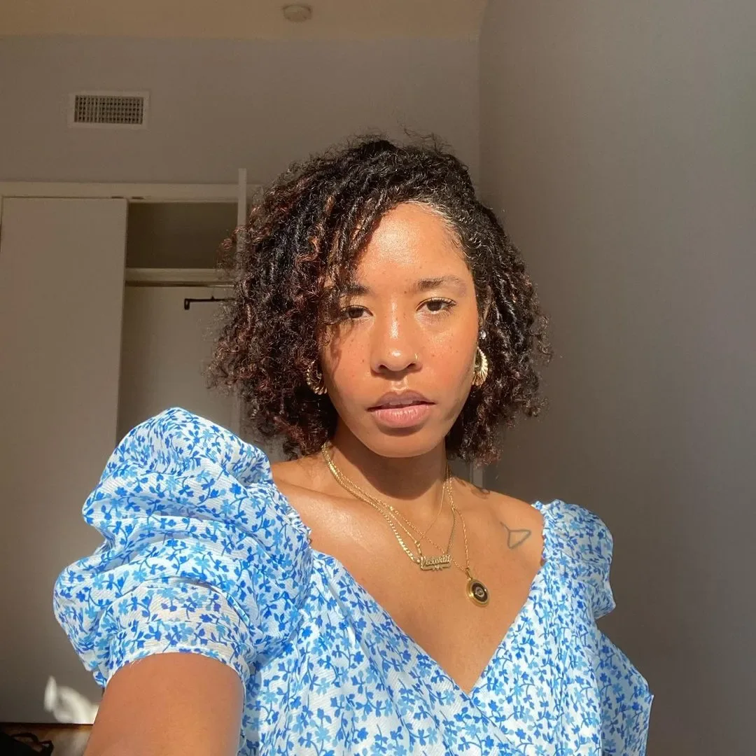 Shorter medium curly haircut with layered shape and side volume for thin fine hair