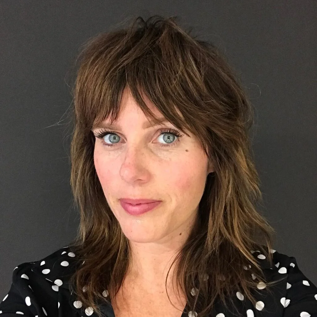 Soft brown medium shag haircut with curtain bangs and natural movement for thin fine hair