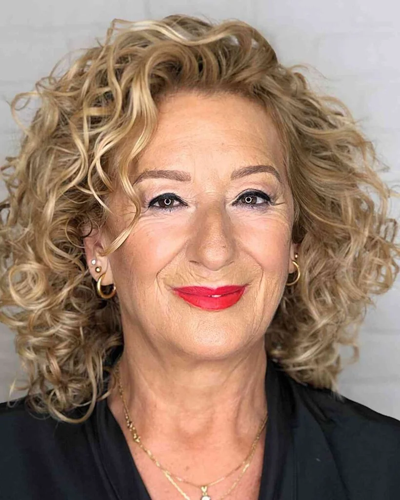Curly blonde medium length haircut with layered volume for thin fine hair