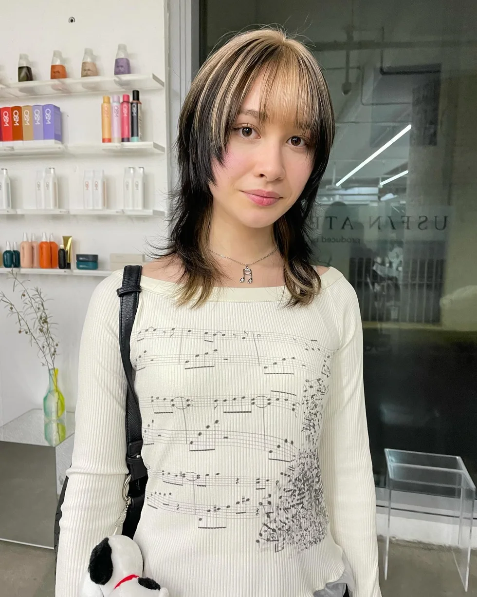 Wispy medium wolf cut with curtain bangs and thick layered ends