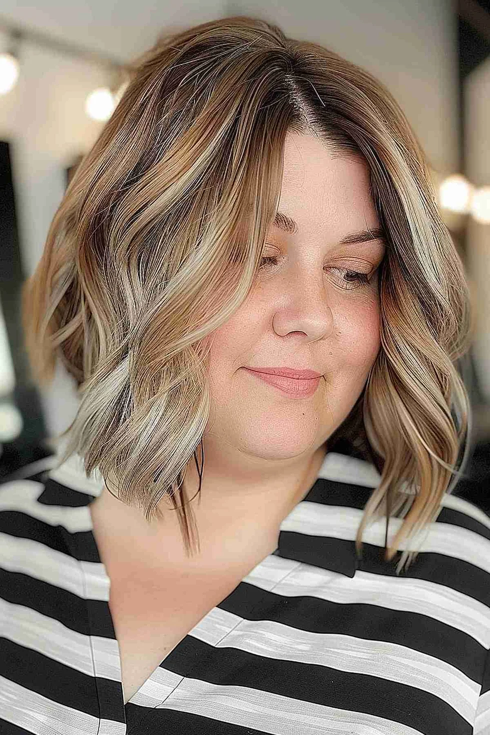 Curved blonde lob with thick face-framing layers