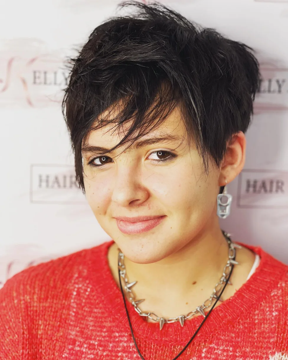 ear straight golden pixie with wispy fringe shown as a messy pixie cut with bangs idea, featuring side part