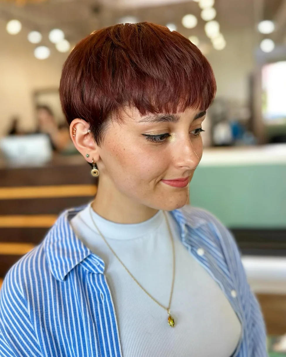 ear straight chestnut undercut with side swept fringe shown as a messy pixie cut with bangs idea