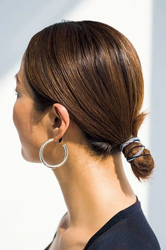chest straight chestnut bun shown as a mother of the bride hairstyles idea, featuring light layering