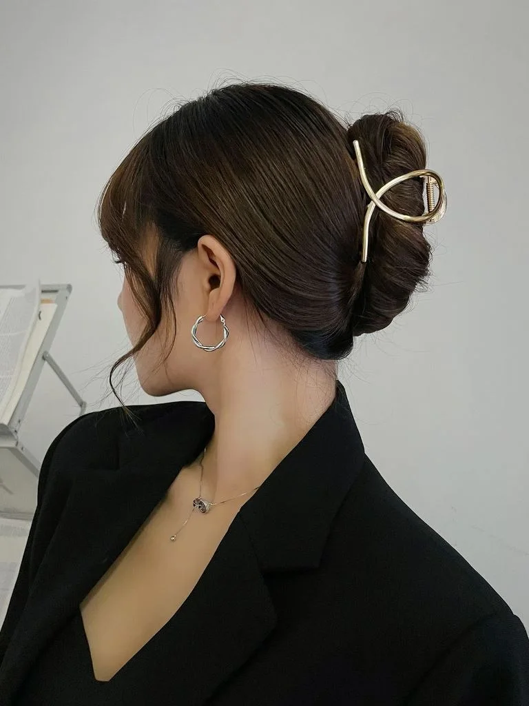 shoulder wavy blonde bun shown as a mother of the bride hairstyles idea