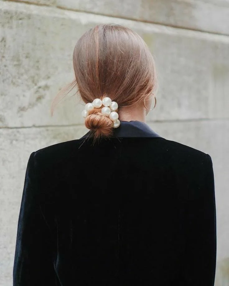 shoulder wavy blonde updo shown as a mother of the bride hairstyles idea, featuring blonde color