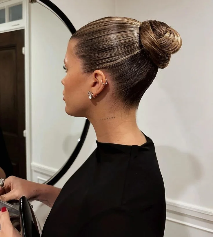shoulder wavy blonde bun shown as a mother of the bride hairstyles idea, featuring wavy texture