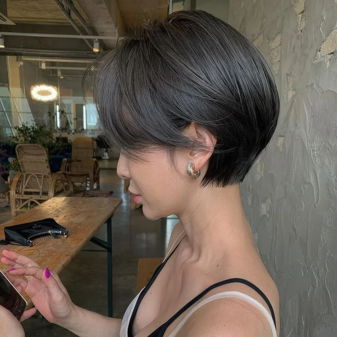 Photo showing black pixie bob, with the hairstyle clearly visible.
