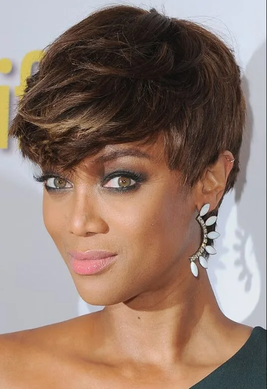 Tousled brunette pixie cut with long side bangs and lifted texture