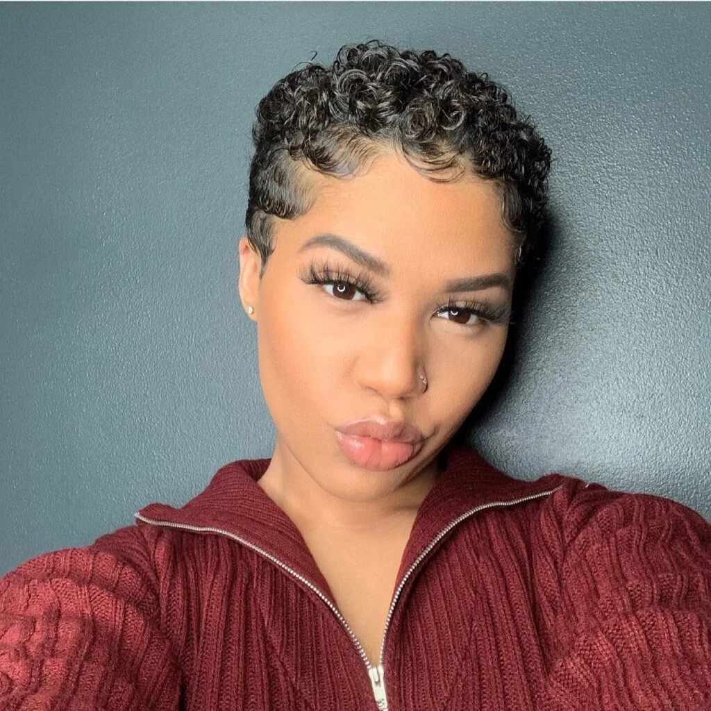 Sculpted short pixie cut with molded side bangs and a neat hairline