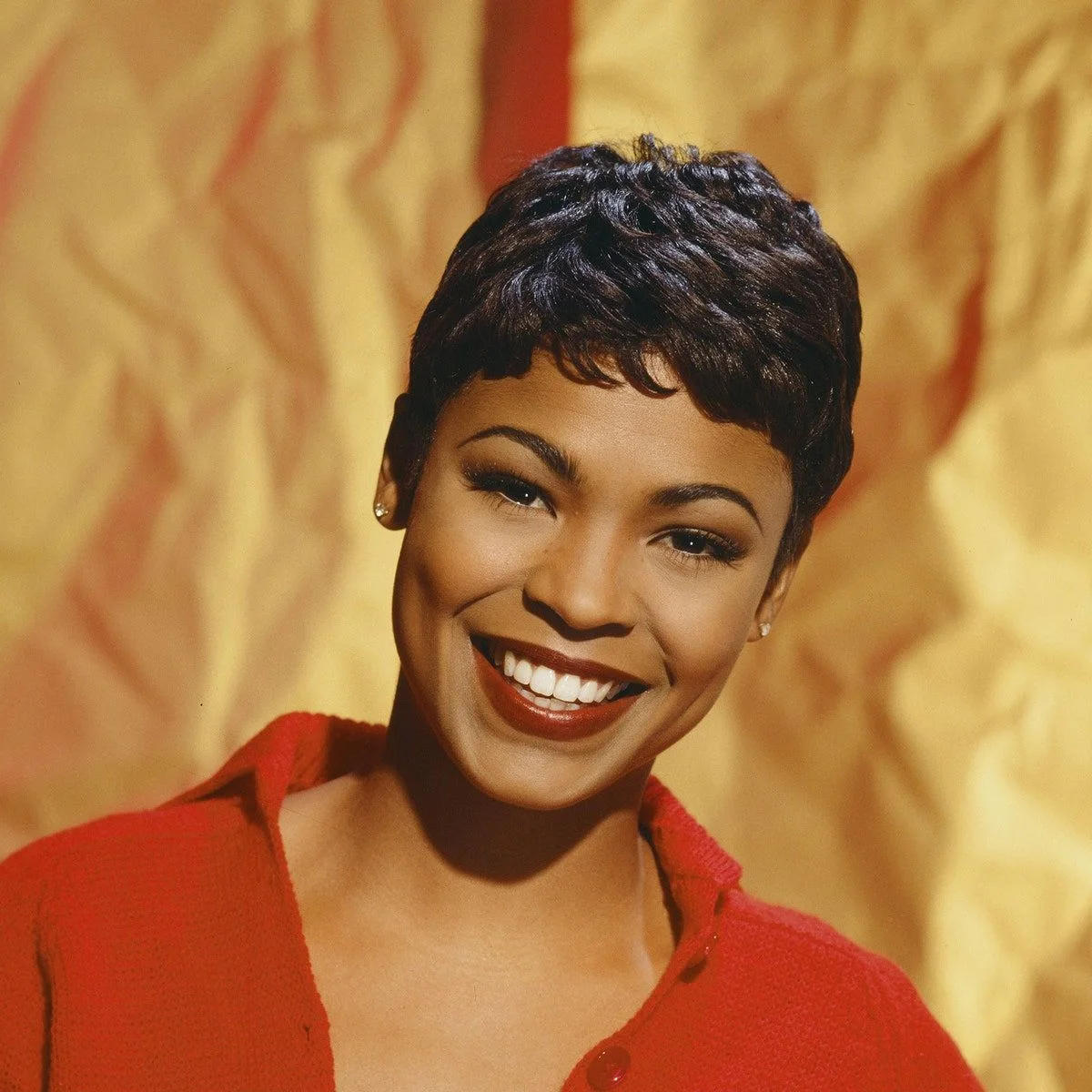 Soft cropped black pixie cut with short bangs and gentle texture