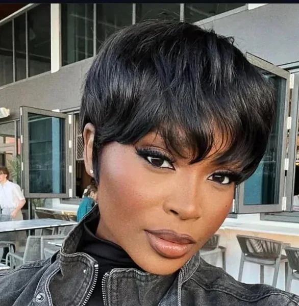 Full black pixie cut with long bangs and glossy short layers