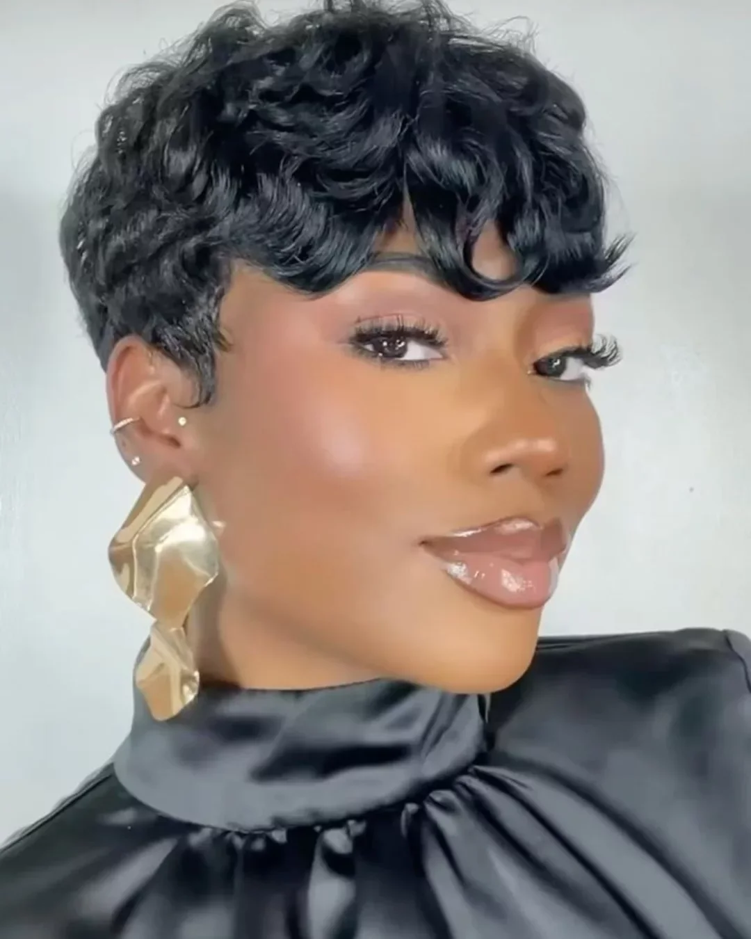 Blue black pixie cut with textured bangs and short layered sides