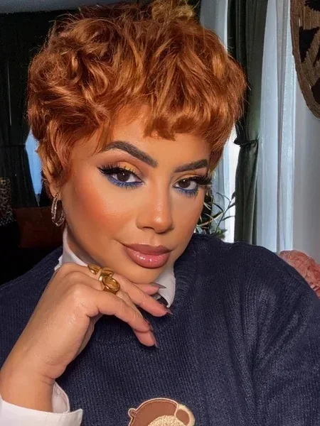 Copper curly pixie cut with short bangs and rounded cropped texture