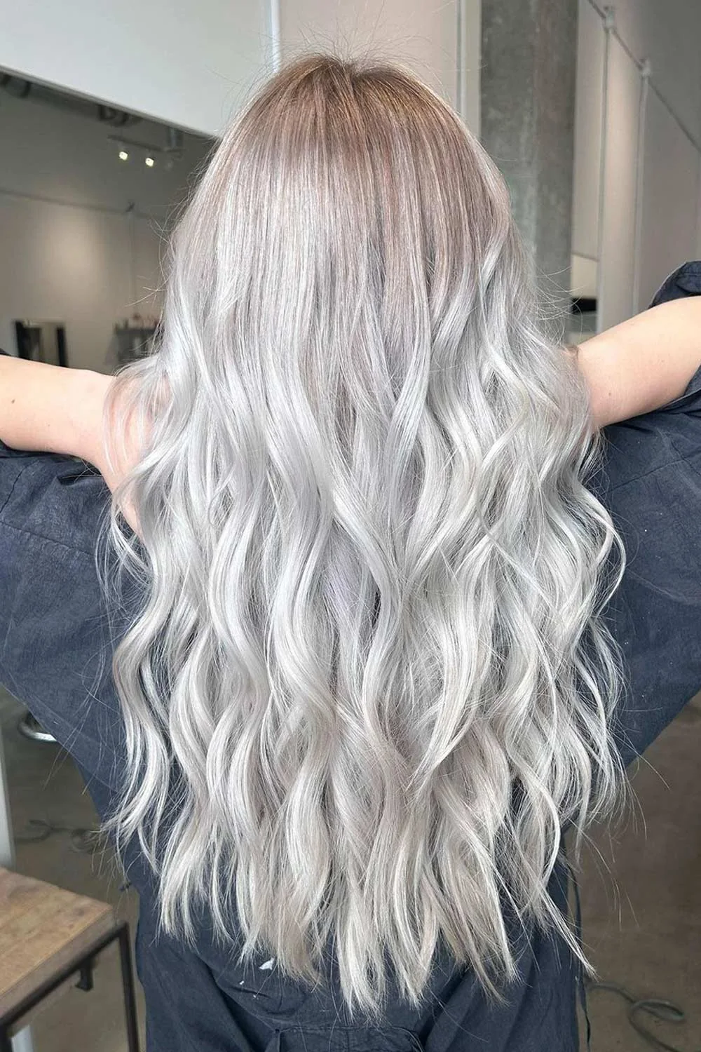 Long silver-blonde waves viewed from behind with soft root shading