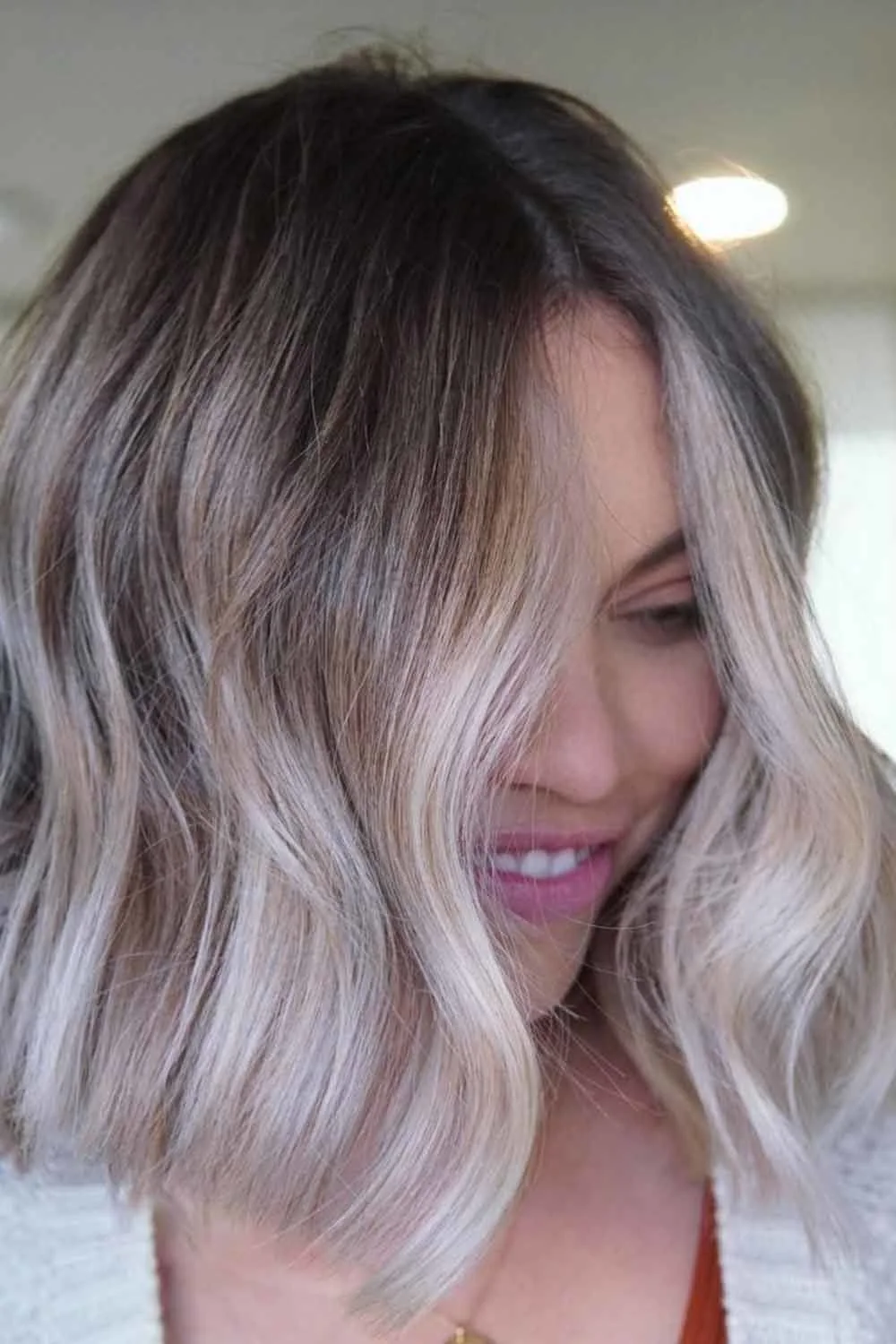 Pale blonde wavy front sections against darker roots
