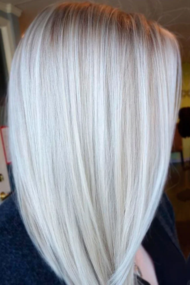 Back view of straight icy blonde hair with a tapered bottom